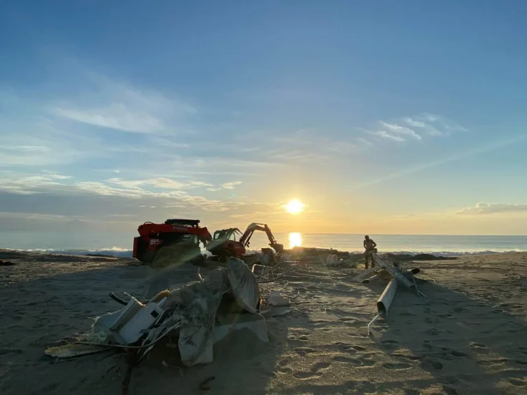 Equipment working on the beach at sunrise