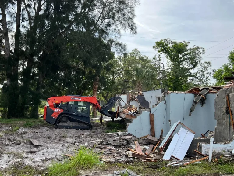 Track loader at a demolition site with block walls coming down