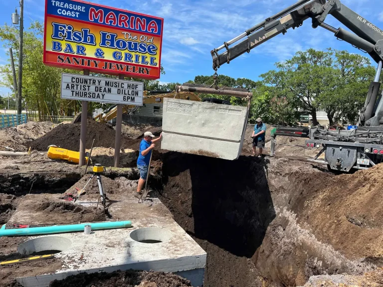 Crotty Services crew setting a new septic tank with a crane