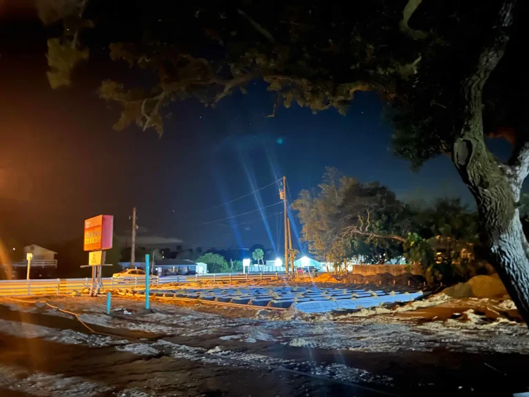 Commercial drainfield work lit at night
