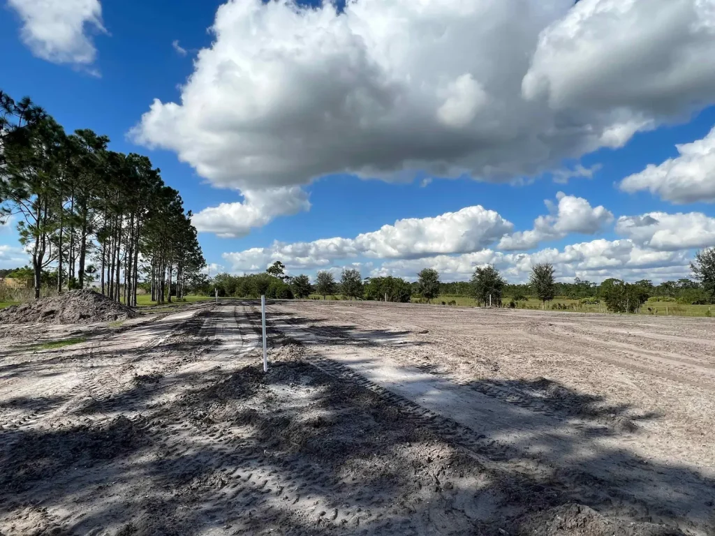 Cleared and graded lot under a cloudy sky