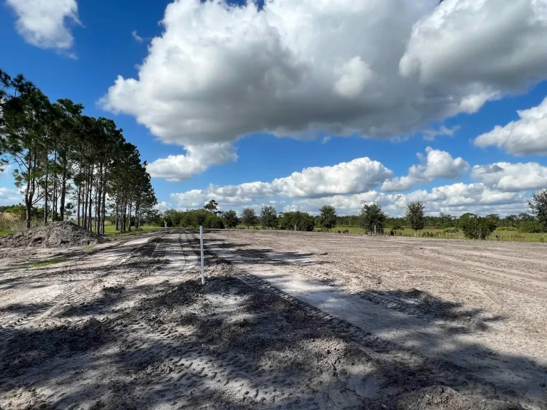 Cleared and graded lot under a cloudy sky