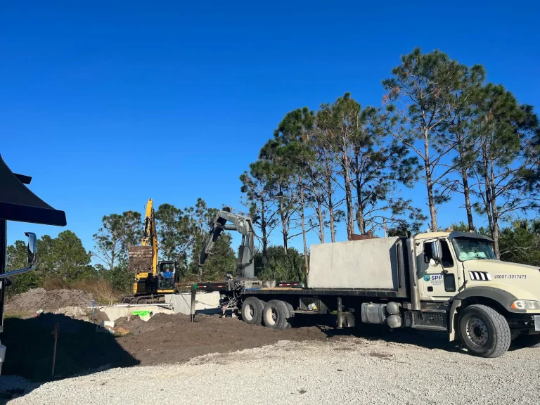 Flatbed truck delivering septic tanks