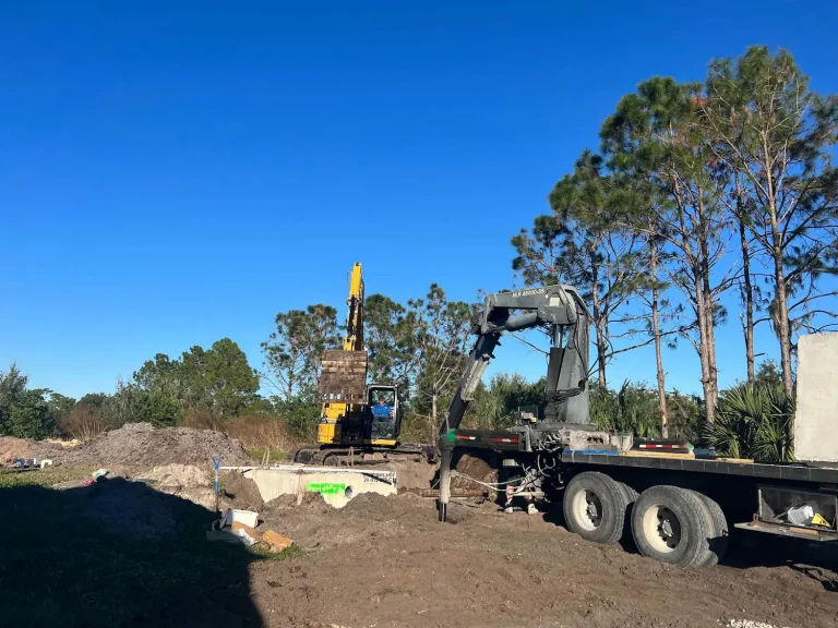 Flatbed truck and excavator on a septic job