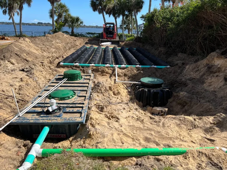 Drainfield installation with black pipe and a sand bed