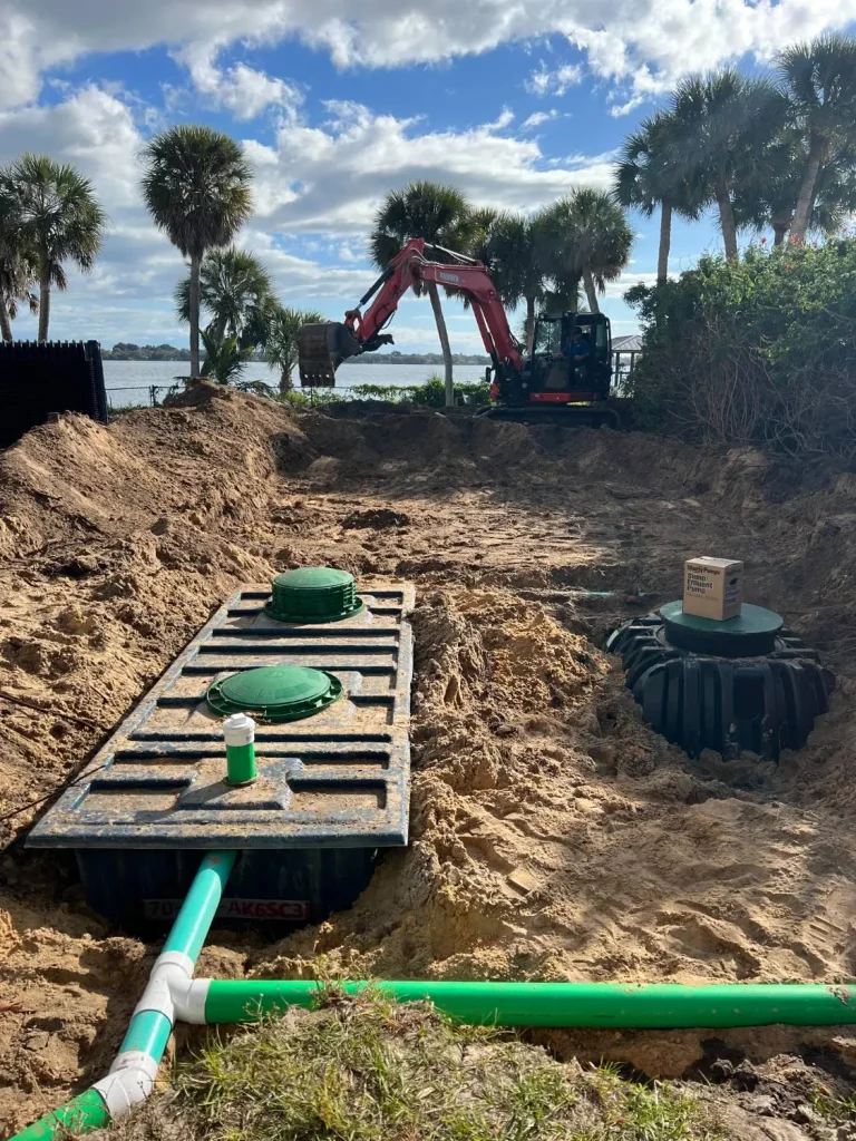 Drainfield with green lids and piping, blue sky